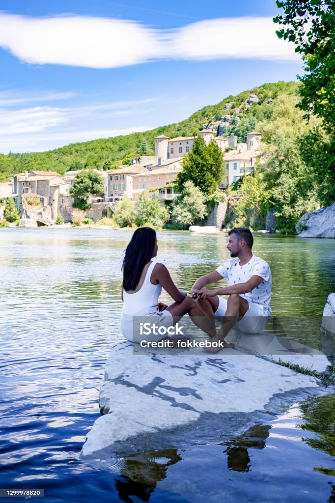 Balazuc in Southern France, Ardeche district France Balazuc in Southern France, Ardeche district France. couple mid age men and woman on a road trip in France visiting the village of Balazuc Valence - Drôme Stock Photo