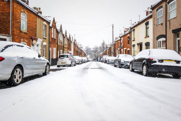 istock British street under winter snow fall in england uk 1299979391