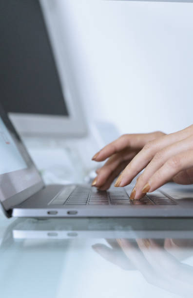 istock Young woman working on her laptop at home 1299982218