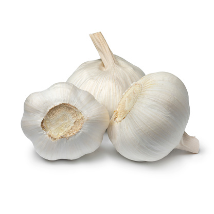 Heap of white whole garlic bulbs isolated on white background