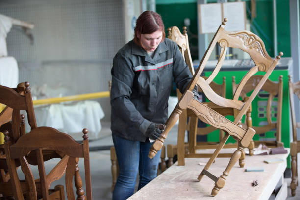 istock A factory for processing wood and making chairs. Working at the factory makes a chair. Making expensive furniture 1299982580