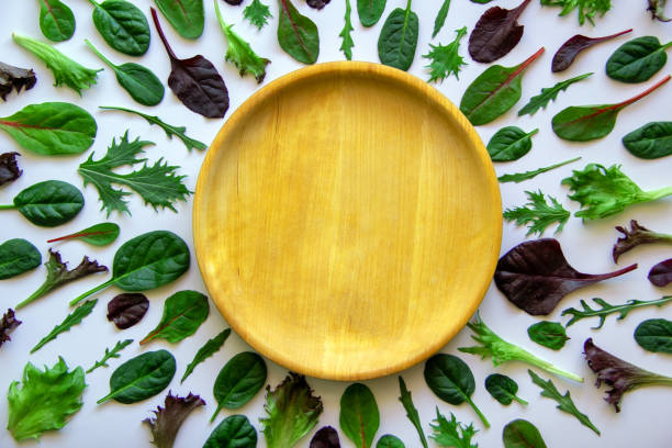 istock Salad leaves and wooden plate. 1299982624