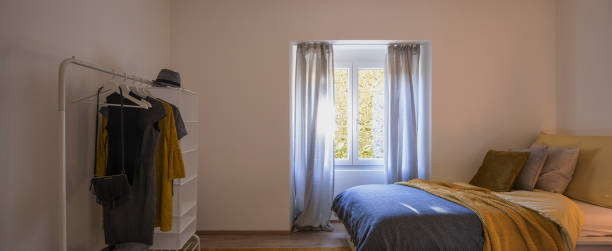 istock Modern bedroom with two singles beds with clean bed sheets and large pillow above. White wall 1299983532