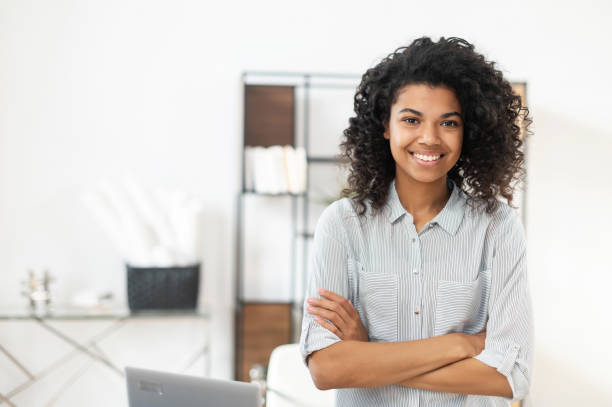 istock African American woman standing with arms crossed 1299984921