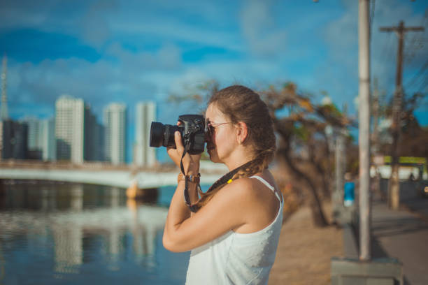 istock Close-up image of urban female photographer using camera 1299985334