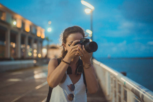 istock Close-up image of urban female photographer using camera 1299985375