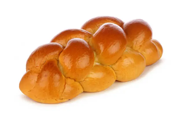 Fresh braided egg bread. Side view isolated on a white background.