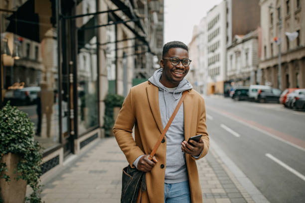 istock Fashionable african american man using modern technology 1299986841