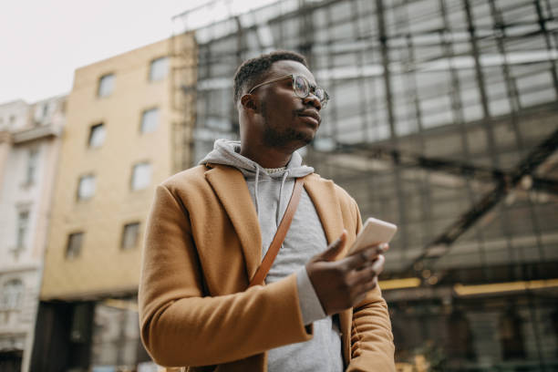 istock Fashionable african american man using modern technology 1299986929