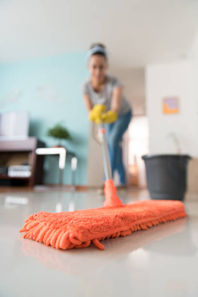 istock Close-up on a woman mopping the floor at home 1299988067