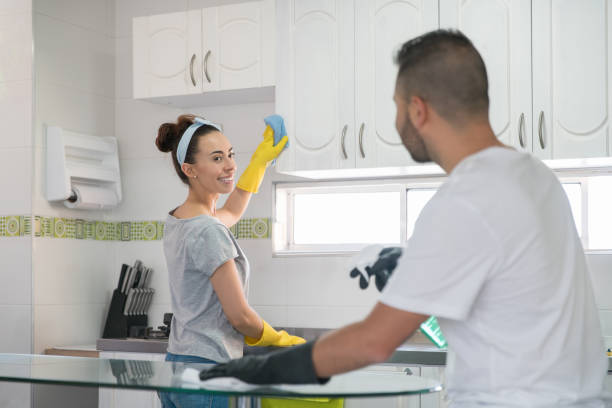 istock Happy couple doing house chores together 1299988080