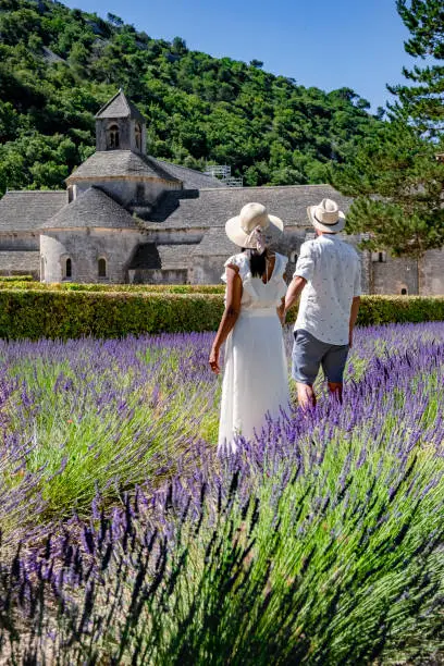Senanque Abbey Gordes Provence Lavender fields Notre-Dame de Senanque, blooming purple-blue lavender fields Luberon France. Europe, couple visiting the Provence France, men , woman mid age on vacation