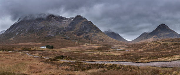 istock Majestic landscape image view down Glencoe Valley in Scottish Highlands with mountain ranges in dramatic Winter lighting 1299989151