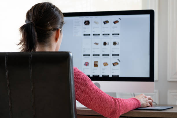 istock Woman Grocery Shopping Online on her Computer from Home 1299992071