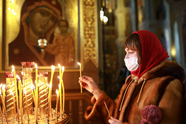 istock Woman in protective mask in cathedral 1299992375
