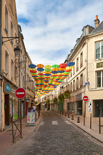 Laon, France - September 08 2020: Rue St Jean shaded by colorful umbrellas.