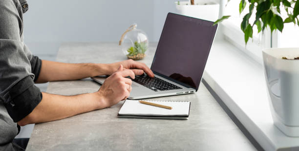 istock Young happy designer working on laptop from home, freelance concept 1299994836