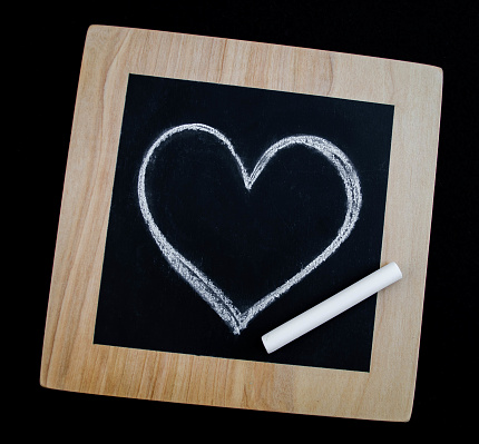 A small chalkboard with a hand drawn heart in the middle