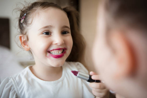 istock Little girl's first lipstick 1299996738