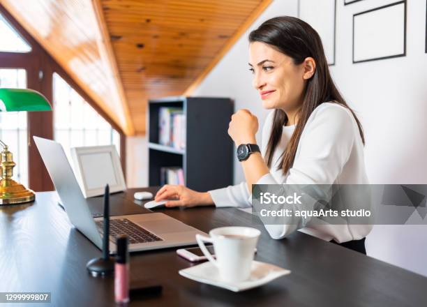 A Young Business Woman Is Working On Laptop Computer And Having Video Conference Call Via Computer At Home Office Online Call Meeting Working Remotely At Home Stock Photo - Download Image Now