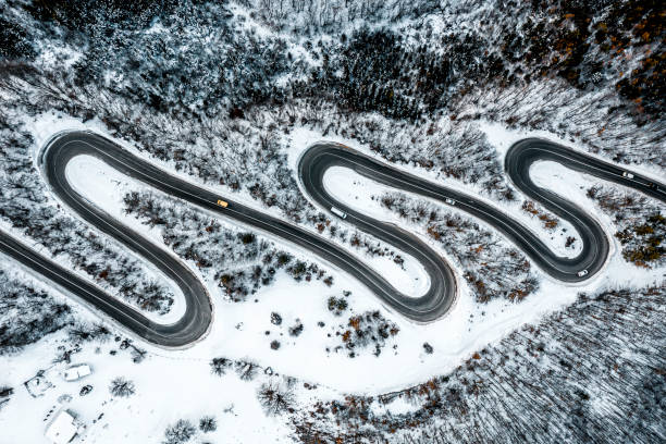 istock Curvy road with cars seen from a straight down perspective 1300003109