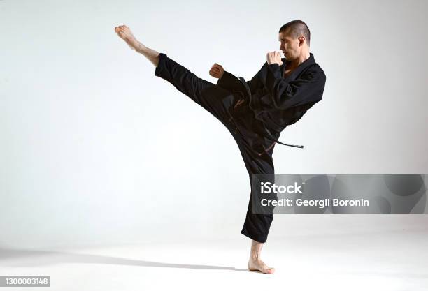 Fighting Guy In Black Kimono Fighter Shows Kudo Technique On Studio Background With Copy Space Mix Fight Concept Stock Photo - Download Image Now