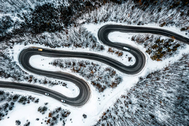 istock Several vehicles on the mountain winding road seen directly from above 1300003170