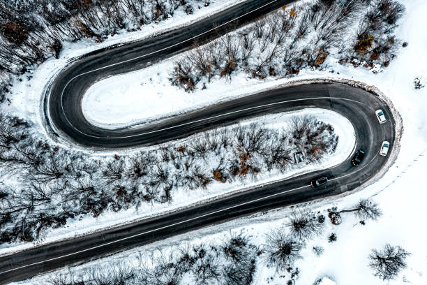 istock Perfect asphalt curves surrounded with snow 1300003380