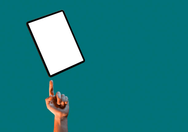 istock Tablet mock up template with blank screen and male hand on green background with copy space for advertising 1300003409