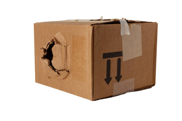 istock Large hole in a damaged cardboard box 1300003448