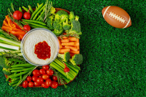 healthy vegetable platter with football ball for american football game party. close up. - american football football food snack imagens e fotografias de stock