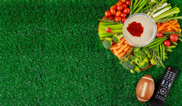 colorful vegetable platter with football ball for american football game party. - american football football food snack imagens e fotografias de stock