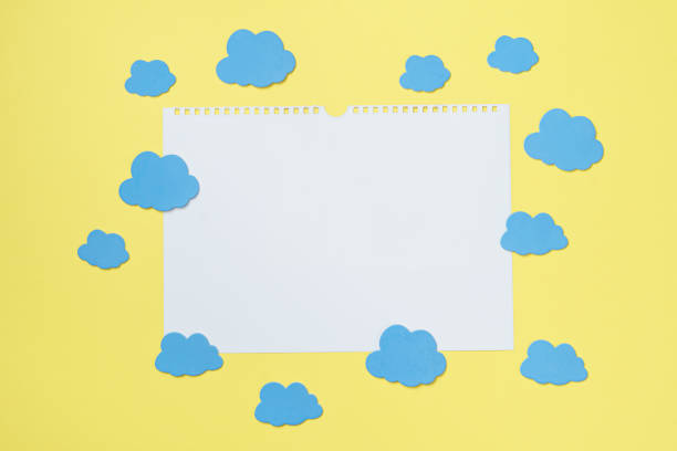 istock Creative composition of white paper card surrounded by clouds mockup, copy space 1300005045