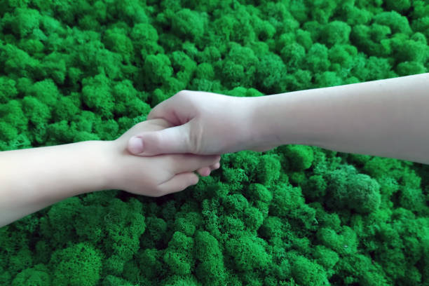 hands on a green background. green moss in the office
