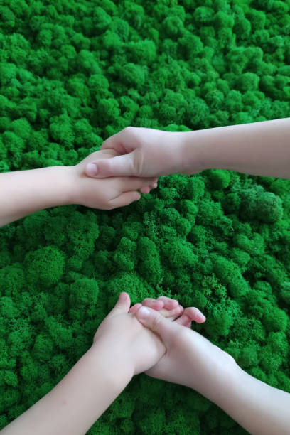 hands on a green background. green moss in the office