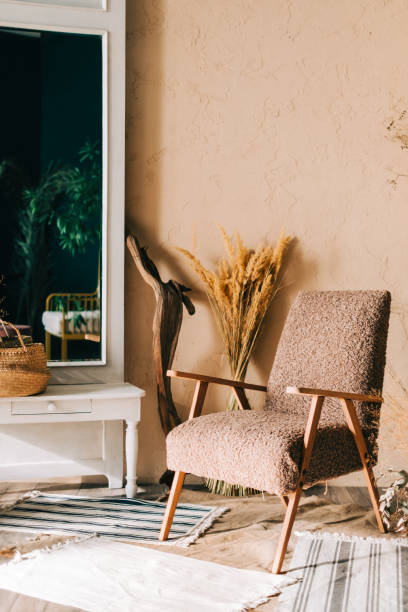 istock Big mirror and empty armchair with decorations, home comfort, interior details. 1300007496