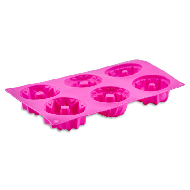 istock Pink silicone muffin form isolated on white background. Cake cup, silicone mold, bakeware. 1300007745