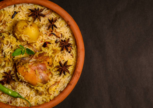 istock Chicken biryani on black background, Spicy indian handi biryani. 1300007887