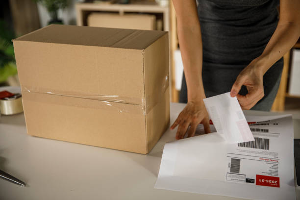 istock Pilling off labels to put on a package 1300007901