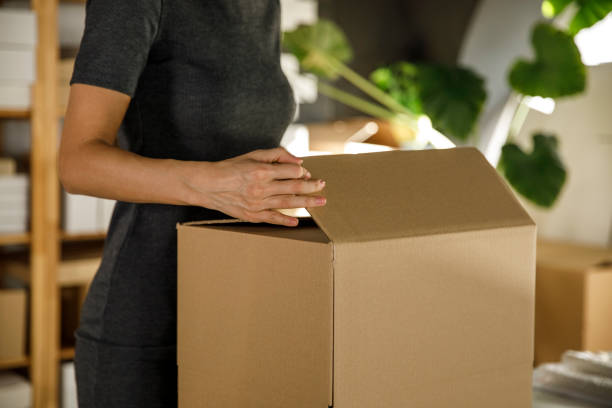 istock Businesswoman packing customer's order 1300008636