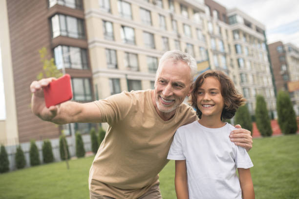 istock A dad and a son feeling good and making selfie 1300008887