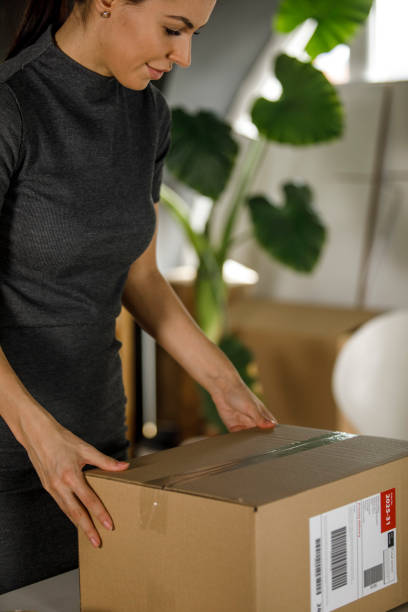 istock Young female entrepreneur preparing a package in her office 1300009137