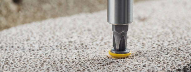 istock screwdriver screw and dowel in a concrete wall background 1300009149