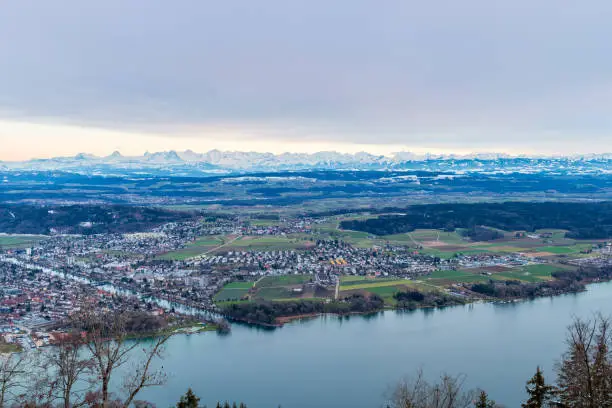View from the municipality of Magglingen above the city of Biel Bienne over the urban area, the flatlands of the canton of Bern to the swiss alps. in the foreground the lake biel and the aare river