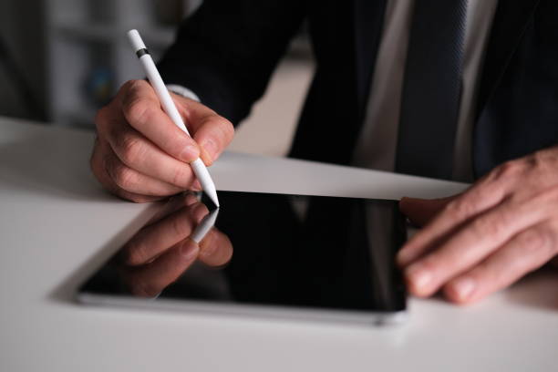 istock Businessman Signing Digital Contract On Tablet Using Stylus Pen 1300012464