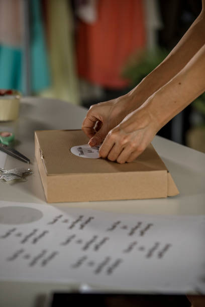 istock Sticking a label on a package to be send out 1300012583