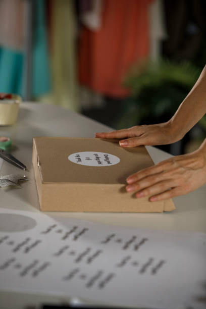 istock Sticking a ''thank you'' note on a package for a customer 1300012630