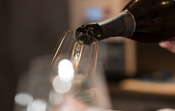 istock pouring champagne into champagne glasses 1300013913