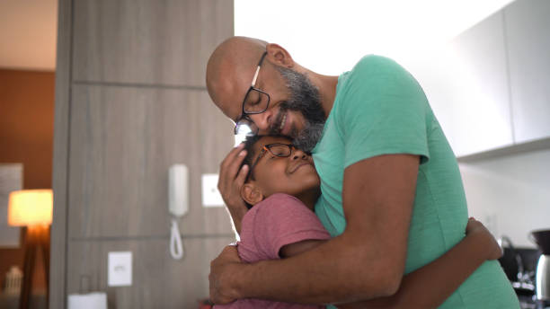 Father embracing son at home