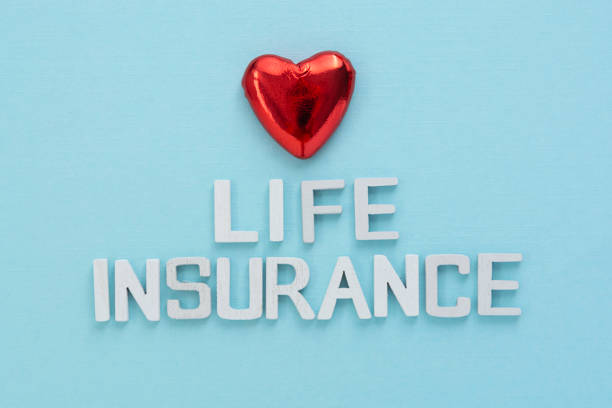 istock Life insurance text. Red heart over blue background. 1300014434
